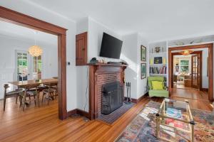 a living room with a fireplace and a dining room at Classic Stockbridge Cottage in Stockbridge +49 photos