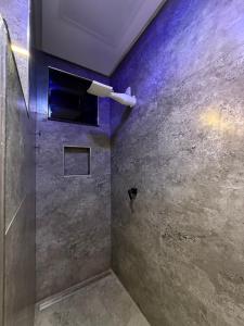 a bathroom with a shower with a light on the wall at Hotel Omega in Oiapoque