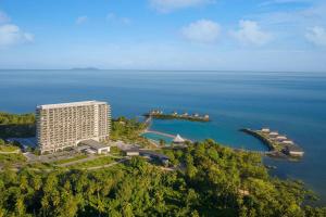 an aerial view of a resort on a island in the ocean at Manado Marriott Resort & Spa in Manado