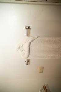 a bathroom with a white towel hanging on a wall at Terrazas del Golfo in La Palma +139 photos