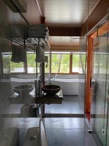 a bathroom with two sinks and a bath tub at Xuan Son Lakeside Bungalow in Ninh Binh