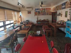 a restaurant with tables and chairs and a red carpet at Hotel shirahama in Shirahama