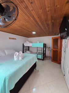 a bedroom with a bed with towels on it at Hotel El Balcon de madera in Norcasia +38 photos