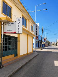a building with a sign on the side of a street at Hotel Tulipanes in Villahermosa