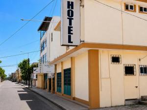 a building with a sign on the side of a street at Hotel Tulipanes in Villahermosa