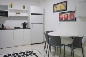 a kitchen with a table and chairs and a refrigerator at Casa Dunia - 2 BR Open Sea View Apartment in Sahl ‘Almā +21 photos