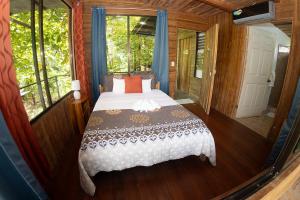a bedroom with a bed in a room with windows at Terrazas del Golfo in La Palma