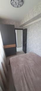 a bedroom with a bed and a black door at Гостевой дом in Sevan +5 photos