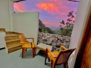 a balcony with two chairs and a window with a view at Lavenia Mountain Holiday home in Bandarawela