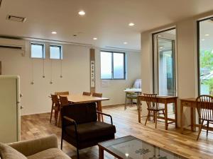 a living room with a table and chairs at Kita-Kamakura 520ゴーニーマル in Kamakura