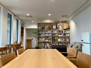 a dining room with a large wooden table and chairs at Kita-Kamakura 520ゴーニーマル in Kamakura