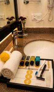 a bathroom counter with a sink and a towel on a tray at Ello Hotels in Bangalore +77 photos