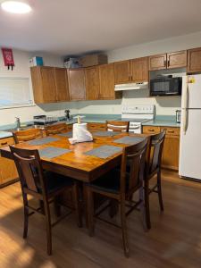 a kitchen with a wooden table with chairs and a refrigerator at Hope Sunshine Valley Scenic Mountain View House 3BR 3Bath in Hope +13 photos