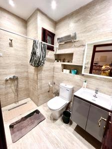 a bathroom with a toilet and a sink at Blue Pearl city in Chefchaouen +6 photos
