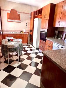 a kitchen with a black and white checkered floor at Blue Pearl city in Chefchaouen