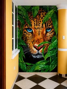 a mural of a leopard in the jungle at Hostal Mariscal Sucre in Tababela +15 photos