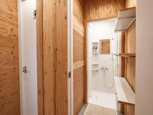 a bathroom with a shower and a toilet and a sink at Ishigaki Guesthouse HIVE in Ishigaki Island +30 photos