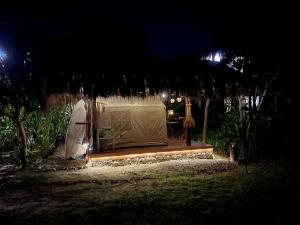 a tent is set up in a yard at night at Soffta Surf Ranch in General Luna
