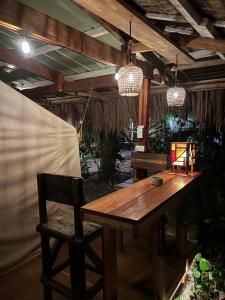 a wooden table and a chair in a room at Soffta Surf Ranch in General Luna