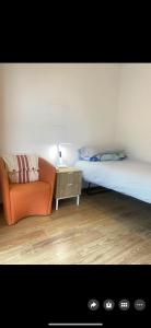 a bedroom with a bed and a chair and a table at Nice quite stay in Perth