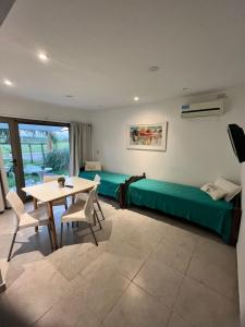 a room with a bed and a table and chairs at Chajari Suites in Chajarí +39 photos