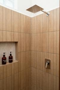 a bathroom with a shower with two soap dispensers at Saules Armonía in Cancún +36 photos