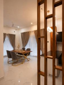 a dining room with a table and chairs at Rivera Residency , Kazhakuttom in Murukkumpuzha