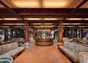 a lobby with couches and a bar in the middle at Ui Valley Resort in Ninh Binh
