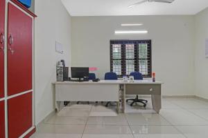 an office with a desk with a computer on it at Hotel O Skywind in Trivandrum