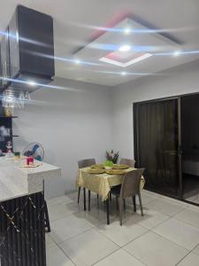 a kitchen with a table and chairs in a room at Newly Opened Mini Suite in Manta +3 photos