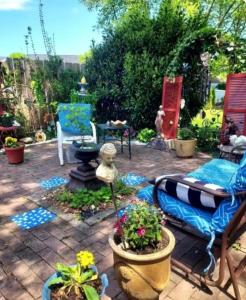 a patio with a couch and some plants at George School Garden Homestay in Langhorne +15 photos