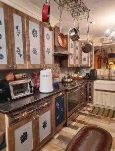 a kitchen with wooden cabinets and a counter top at George School Garden Homestay in Langhorne