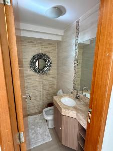 a bathroom with a sink and a toilet at Sobrado Flamboyant in Goiânia