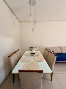 a dining room table with chairs and a white table at Sobrado Flamboyant in Goiânia +10 photos