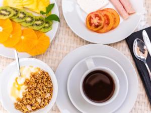 a table with plates of food and a cup of coffee at &Tales Hotel - Óbidos in Óbidos +62 photos