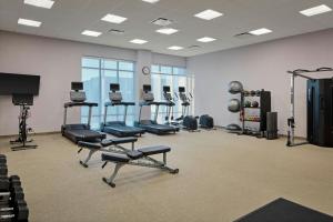 a gym with several treadmills and machines in a room at SpringHill Suites by Marriott High Point Downtown in High Point