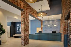 a lobby with a brick wall and a waiting room at SpringHill Suites by Marriott High Point Downtown in High Point