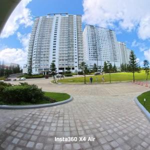 a large apartment building with a park in front of it at Condo Unit at Cool Suites SMDC Wind Tagaytay in Tagaytay