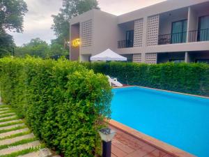 a swimming pool in front of a building at The Camp in Kanchanaburi City +12 photos