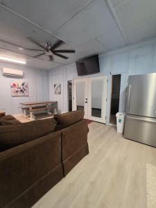 a living room with a couch and a refrigerator at River Run Bo's Place in Kerrville