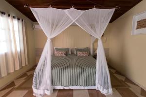En eller flere senge i et værelse på Pousada Do Rio Mutum