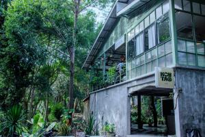 a person standing on the balcony of a new tin building at Koh Tao Stay in Ko Tao
