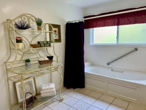 a bathroom with a tub and a sink and a bath tub at Mallard Cove - lakeside pet friendly in Robbinsville +14 photos