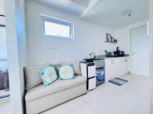 a living room with a couch and a kitchen at Condo Unit at Cool Suites SMDC Wind Tagaytay in Tagaytay +15 photos