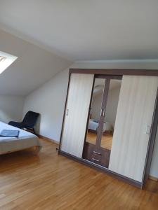 a mirror in a room with a bed and a bedroom at “Airīši” in Alūksne +13 photos