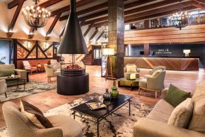 a lobby with couches and chairs and a table at Meliá Sierra Nevada in Sierra Nevada +88 photos