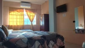 a hotel room with a bed and a window at Hostal La GRAN Familia in Manta