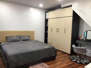 a bedroom with a bed and a dresser and a mirror at CoNa Homestay in Ðồng Khê Sâu