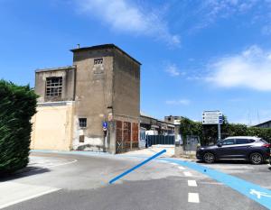 a car parked in a parking lot next to a building at Sonček 2 in Izola
