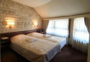 Postel nebo postele na pokoji v ubytování Hotel Restaurant La Porte d'Octodure